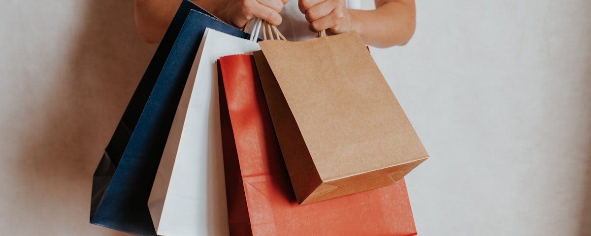 Person holding colorful shopping bags